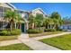 Front view of townhome with landscaping and sidewalk at 8932 Manor Loop # 207, Lakewood Ranch, FL 34202