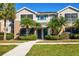 Tan two-story townhome with palm trees and a walkway at 8932 Manor Loop # 207, Lakewood Ranch, FL 34202