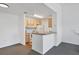 Simple kitchen featuring light wood cabinets and a breakfast bar at 8932 Manor Loop # 207, Lakewood Ranch, FL 34202