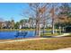 Peaceful walkway along the lake with benches and scenic views at 8932 Manor Loop # 207, Lakewood Ranch, FL 34202