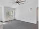 Bright living room with grey carpet and access to balcony at 8932 Manor Loop # 207, Lakewood Ranch, FL 34202