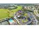 Aerial view of community clubhouse, pool, tennis courts, and parking at 9499 Millbank Dr # 2721, Sarasota, FL 34238