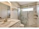 Modern bathroom with white shaker cabinets, marble countertop and a walk in shower at 9499 Millbank Dr # 2721, Sarasota, FL 34238