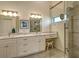 Elegant bathroom with double vanity, marble countertops, and a large glass shower at 9499 Millbank Dr # 2721, Sarasota, FL 34238