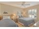 Cozy guest bedroom with two twin beds, ample natural light, and decorative accents at 9499 Millbank Dr # 2721, Sarasota, FL 34238