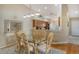 Bright dining room with wood floors and glass-top table at 9499 Millbank Dr # 2721, Sarasota, FL 34238