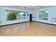 Bright exercise room with wood floors, windows, and exercise equipment at 9499 Millbank Dr # 2721, Sarasota, FL 34238