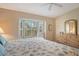 Large main bedroom with a dresser and bay window with plantation shutters at 9499 Millbank Dr # 2721, Sarasota, FL 34238