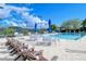 Relaxing pool area with lounge chairs and patio tables at 9499 Millbank Dr # 2721, Sarasota, FL 34238