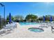 Community pool with patio furniture and hot tub at 9499 Millbank Dr # 2721, Sarasota, FL 34238