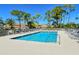 Community pool with ample lounge chairs for residents to relax at 9499 Millbank Dr # 2721, Sarasota, FL 34238