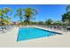 Refreshing community pool surrounded by lush landscaping and lounge chairs at 9499 Millbank Dr # 2721, Sarasota, FL 34238