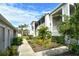 Landscaped walkway leading to condo building entrance at 9499 Millbank Dr # 2721, Sarasota, FL 34238