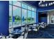 Blue-walled dining area with large windows overlooking the golf course at 9621 Castle Point Dr # 1024, Sarasota, FL 34238