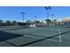 Well-lit tennis court with a central shade structure at 9621 Castle Point Dr # 1024, Sarasota, FL 34238