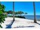 White sand beach with palm trees and waterfront access at 307 Compass Point Dr # 101, Bradenton, FL 34209