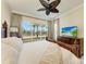 Bright bedroom featuring a king-size bed and water views at 307 Compass Point Dr # 101, Bradenton, FL 34209