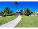 Landscaped entrance to community with paved pathway at 307 Compass Point Dr # 101, Bradenton, FL 34209