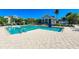 Inviting community pool with spacious deck and lounge chairs at 307 Compass Point Dr # 101, Bradenton, FL 34209