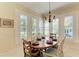 Bright dining area with a copper table, chandelier, and views to the kitchen at 307 Compass Point Dr # 101, Bradenton, FL 34209