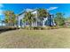 Gray two-story home with palm trees and a manicured lawn at 307 Compass Point Dr # 101, Bradenton, FL 34209