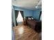 Cozy bedroom with light blue walls and wood-look flooring at 1144 Hoover St, Nokomis, FL 34275