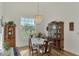 Charming dining room with hardwood floors, a table set for four, and a china cabinet at 1144 Hoover St, Nokomis, FL 34275