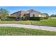 Exterior view of a house with a large backyard, screened patio, and landscaped yard at 1144 Hoover St, Nokomis, FL 34275