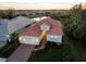 Stunning aerial view of a single-story home with a tile roof and a beautifully landscaped yard at 11816 Altamonte Ct, Venice, FL 34293