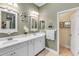 Elegant bathroom with double vanity, and light-colored cabinets at 11816 Altamonte Ct, Venice, FL 34293