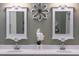 Double vanity bathroom with decorative mirrors and wall art at 11816 Altamonte Ct, Venice, FL 34293