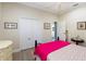 Bright bedroom with a double bed, built-in closet, and a small round table at 11816 Altamonte Ct, Venice, FL 34293