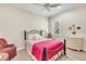 Bright bedroom with a metal bed frame and window seat at 11816 Altamonte Ct, Venice, FL 34293