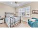 Guest bedroom with metal bed frame and teal accent chair at 11816 Altamonte Ct, Venice, FL 34293