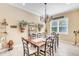 Elegant dining room with a charming table and chairs, decorative wall accents, and a chandelier at 11816 Altamonte Ct, Venice, FL 34293