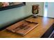 Wooden tray with personalized inscription sits on entry table at 11816 Altamonte Ct, Venice, FL 34293