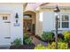 Welcoming front entry with a brick walkway and lush landscaping at 11816 Altamonte Ct, Venice, FL 34293