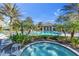 Community hot tub with pool and clubhouse in the background at 11816 Altamonte Ct, Venice, FL 34293