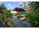 Covered rack storing colorful kayaks near a tranquil lake at 11816 Altamonte Ct, Venice, FL 34293