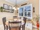 Cozy kitchen nook with a built-in bench, round table, and window seat at 11816 Altamonte Ct, Venice, FL 34293