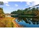 Scenic community lake with wooden footbridge and lush greenery at 11816 Altamonte Ct, Venice, FL 34293