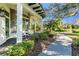 Covered porch with stone facade, ceiling fan, and comfortable seating area at 11816 Altamonte Ct, Venice, FL 34293