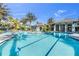 Stunning resort-style pool with palm trees and a clubhouse at 11816 Altamonte Ct, Venice, FL 34293