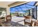 Relaxing screened patio with wicker chairs and picturesque view at 11816 Altamonte Ct, Venice, FL 34293