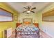 Bedroom with a wooden bed frame, ceiling fan, and window blinds at 1220 De Narvaez Ave, Bradenton, FL 34209