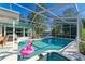 Inviting pool and spa with a screened enclosure and patio furniture at 1220 De Narvaez Ave, Bradenton, FL 34209