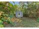 Grey storage shed nestled amongst the greenery at 1220 De Narvaez Ave, Bradenton, FL 34209