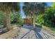 Small storage shed in the backyard with a red door at 1220 De Narvaez Ave, Bradenton, FL 34209