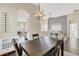 Dining room with dark wood table and modern light fixture at 12728 Avelar Creek Dr, Riverview, FL 33578