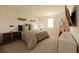 Spacious main bedroom with a king-size bed and mid-century modern furniture at 13006 Bayberry Way, Parrish, FL 34219